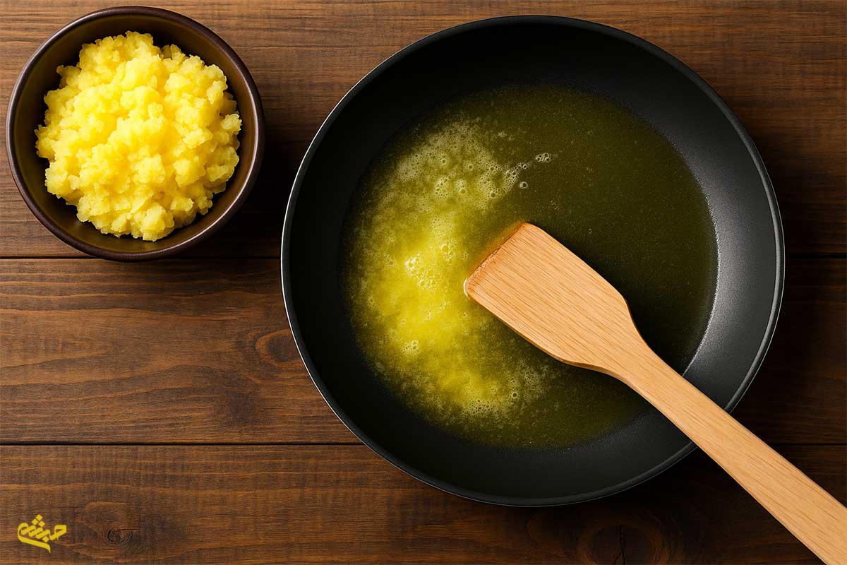 melting clarified butter in a pan with wooden spatula