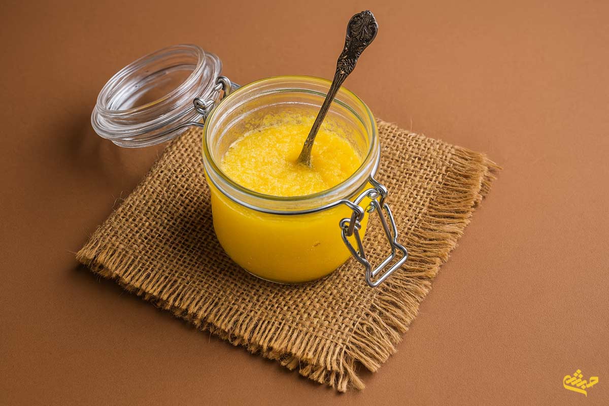 traditional clarified butter in a glass jar with spoon